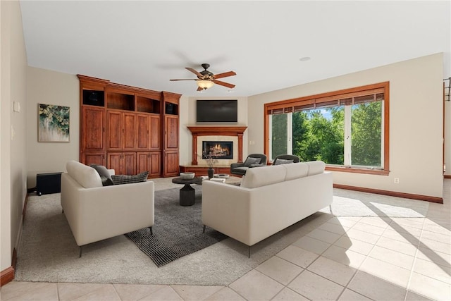 3037 Brookfield Dr, Marion, IA 52302 - living room with ceiling fan, a warm lit fireplace, and light tile patterned flooring
