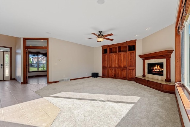 3037 Brookfield Dr, Marion, IA 52302 - unfurnished living room with a fireplace, ceiling fan, carpet floors, recessed lighting, and tile patterned floors