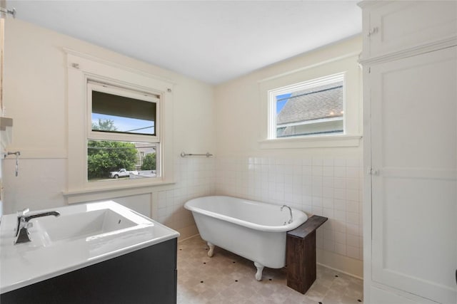 210 16th St SE, Cedar Rapids, IA 52403 - full bath featuring plenty of natural light, a freestanding bath, tile walls, vanity, and tile patterned floors