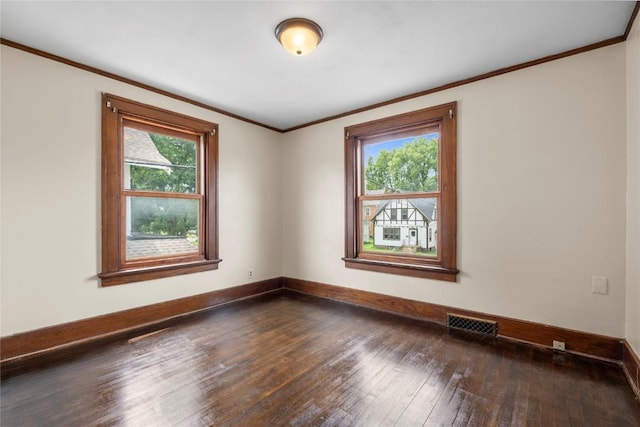 210 16th St SE, Cedar Rapids, IA 52403 - spare room featuring plenty of natural light, dark wood finished floors, and ornamental molding