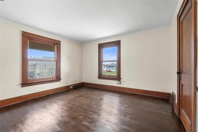 210 16th St SE, Cedar Rapids, IA 52403 - spare room with dark wood-style floors and crown molding