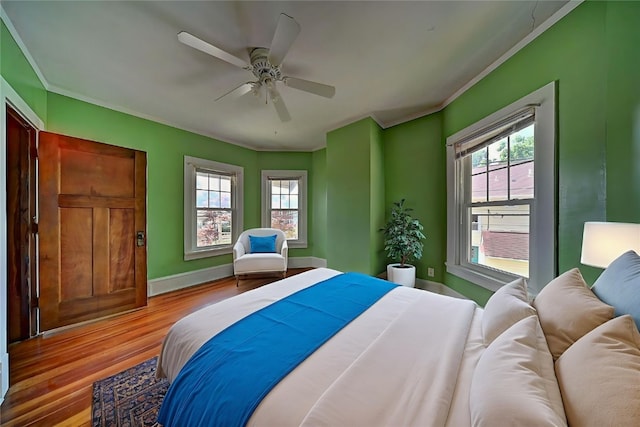 383 21st St SE, Cedar Rapids, IA 52403 - bedroom featuring crown molding, wood finished floors, and ceiling fan