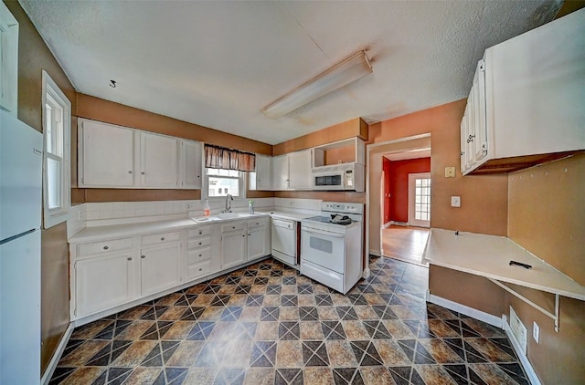 383 21st St SE, Cedar Rapids, IA 52403 - kitchen with white appliances, white cabinetry, and light countertops