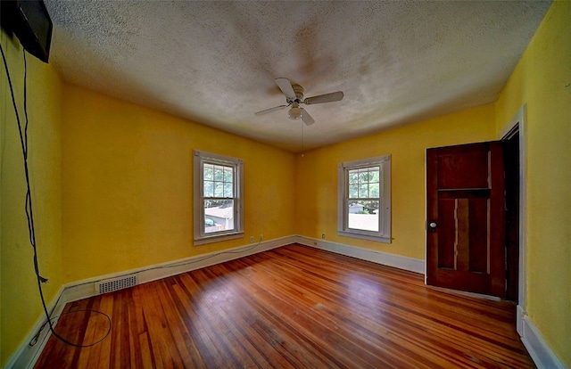383 21st St SE, Cedar Rapids, IA 52403 - empty room with wood-type flooring, a ceiling fan, healthy amount of natural light, and a textured ceiling