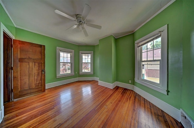383 21st St SE, Cedar Rapids, IA 52403 - unfurnished room with ornamental molding, plenty of natural light, hardwood / wood-style flooring, and a ceiling fan