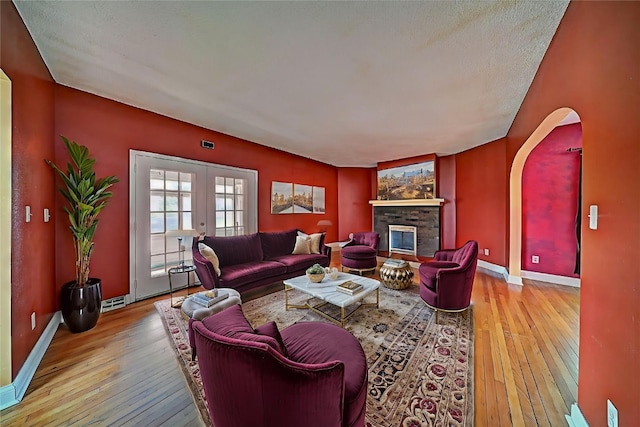 383 21st St SE, Cedar Rapids, IA 52403 - living area featuring hardwood / wood-style flooring, a fireplace, and french doors