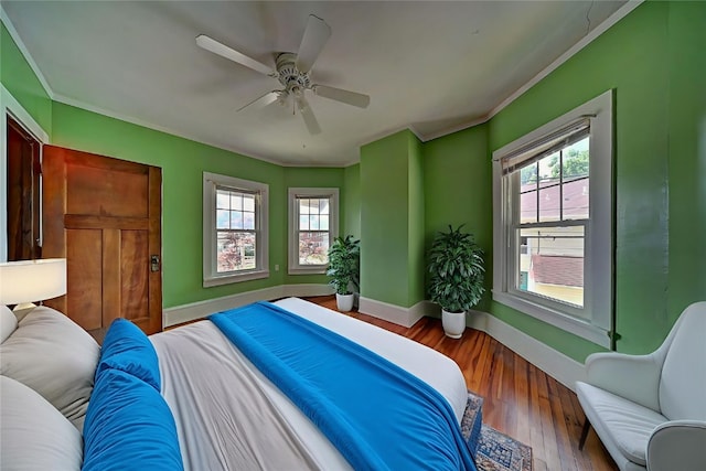 383 21st St SE, Cedar Rapids, IA 52403 - bedroom featuring crown molding, wood finished floors, and ceiling fan