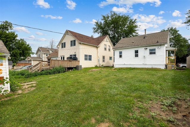 609 34th St NE, Cedar Rapids, IA 52402 - back of house featuring a lawn and a wooden deck