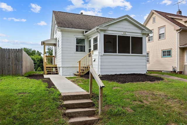609 34th St NE, Cedar Rapids, IA 52402 - view of front of home with a sunroom, a shingled roof, and stairway