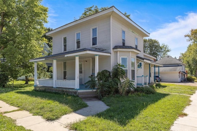 205 E Main St, Lisbon, IA 52253 - view of front of home with a porch, a front yard, and a garage