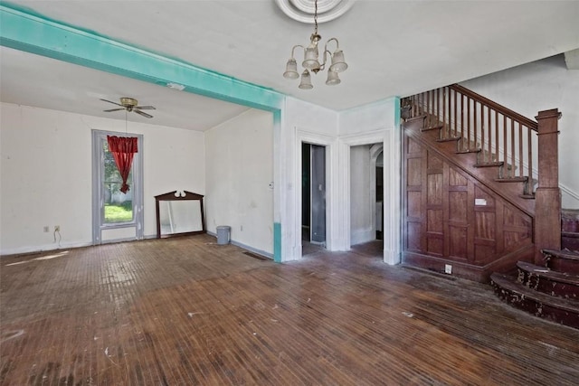 205 E Main St, Lisbon, IA 52253 - unfurnished living room with stairs, wood-type flooring, a chandelier, and arched walkways