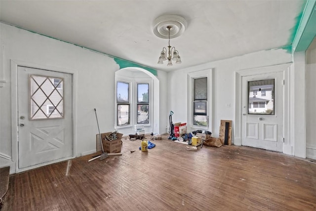 205 E Main St, Lisbon, IA 52253 - foyer entrance featuring wood finished floors, a chandelier, and arched walkways