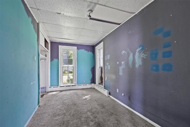 205 E Main St, Lisbon, IA 52253 - carpeted spare room featuring a paneled ceiling and baseboards