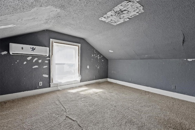 205 E Main St, Lisbon, IA 52253 - additional living space featuring carpet flooring, vaulted ceiling, a textured ceiling, and a wall mounted air conditioner