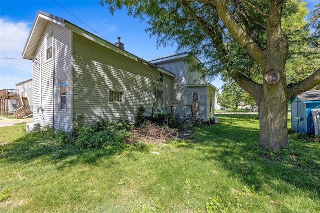 205 E Main St, Lisbon, IA 52253 - view of home's exterior featuring a yard and a storage unit
