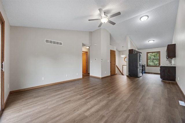 265 Parkview Ct, North Liberty, IA 52317 - unfurnished living room with vaulted ceiling, ceiling fan, and wood finished floors