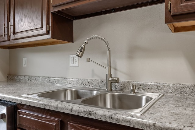 265 Parkview Ct, North Liberty, IA 52317 - kitchen view of light countertops, dark brown cabinets, wall chimney exhaust hood, and dishwasher