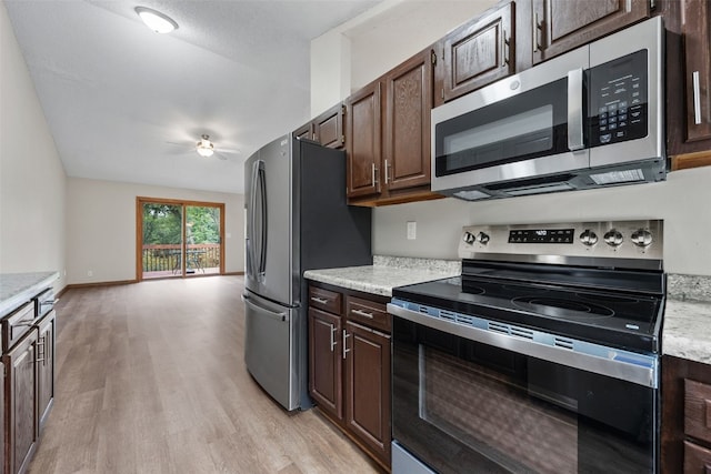 265 Parkview Ct, North Liberty, IA 52317 - kitchen with stainless steel appliances, a ceiling fan, light wood-type flooring, light countertops, and dark brown cabinetry
