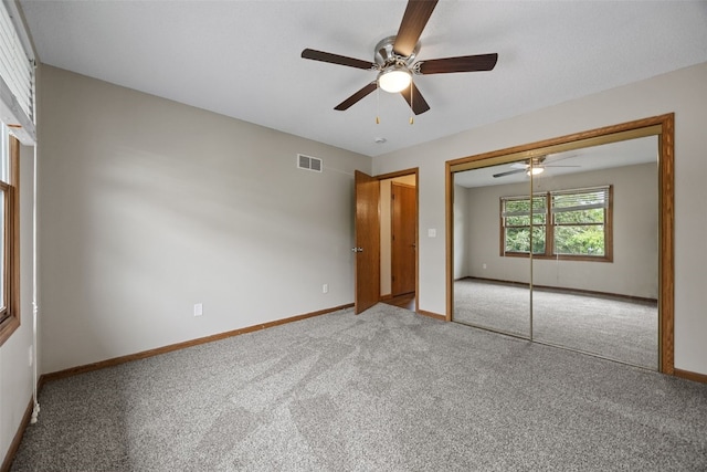 265 Parkview Ct, North Liberty, IA 52317 - unfurnished bedroom with carpet, a closet, and ceiling fan