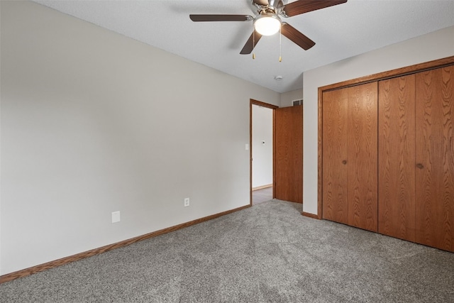 265 Parkview Ct, North Liberty, IA 52317 - unfurnished bedroom with carpet flooring, a closet, and a ceiling fan