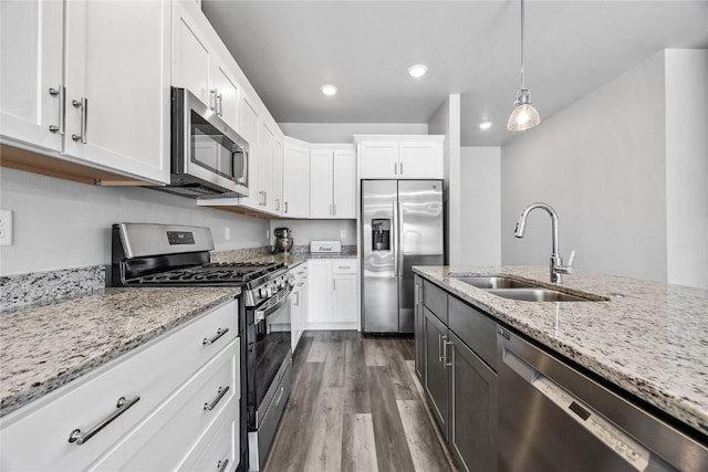 780 Brook Ridge Ave, North Liberty, IA 52317 - kitchen featuring stainless steel appliances, dark wood-type flooring, white cabinetry, light stone countertops, and recessed lighting