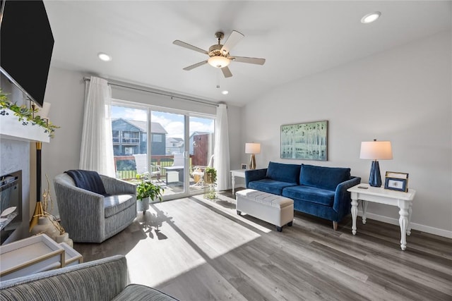 780 Brook Ridge Ave, North Liberty, IA 52317 - living room featuring wood finished floors, a ceiling fan, lofted ceiling, recessed lighting, and a fireplace
