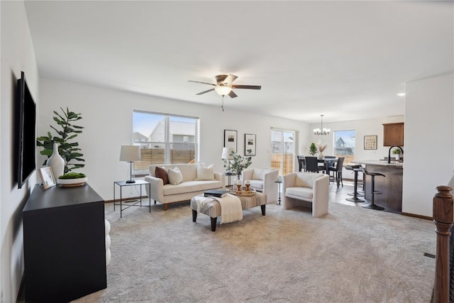 2903 Belle St SW, Cedar Rapids, IA 52404 - living room featuring healthy amount of natural light, a chandelier, carpet flooring, and ceiling fan