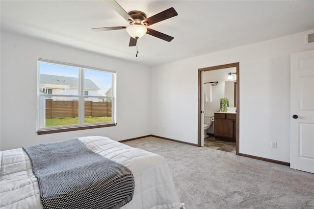2903 Belle St SW, Cedar Rapids, IA 52404 - bedroom with light carpet, ceiling fan, and ensuite bathroom