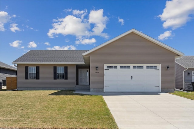 2903 Belle St SW, Cedar Rapids, IA 52404 - ranch-style house featuring a garage, concrete driveway, and a front lawn