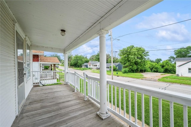 1022 19th St SE, Cedar Rapids, IA 52403 - wooden porch featuring a yard and a residential view