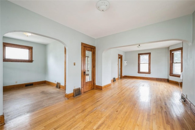 1022 19th St SE, Cedar Rapids, IA 52403 - spare room featuring arched walkways and light wood finished floors