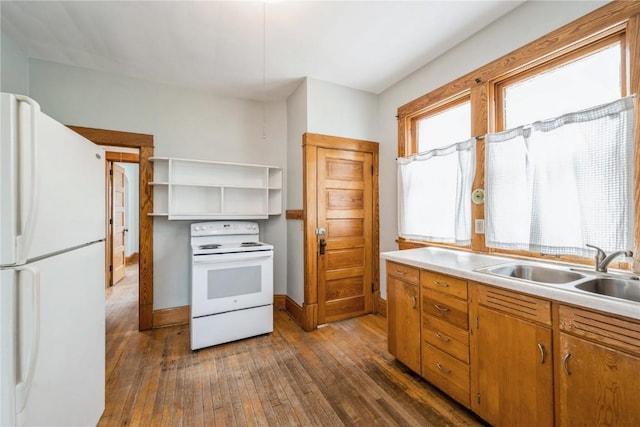 1022 19th St SE, Cedar Rapids, IA 52403 - kitchen with white appliances, dark wood finished floors, light countertops, and brown cabinetry
