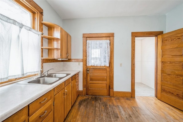 1022 19th St SE, Cedar Rapids, IA 52403 - kitchen with healthy amount of natural light, open shelves, dark wood finished floors, and light countertops