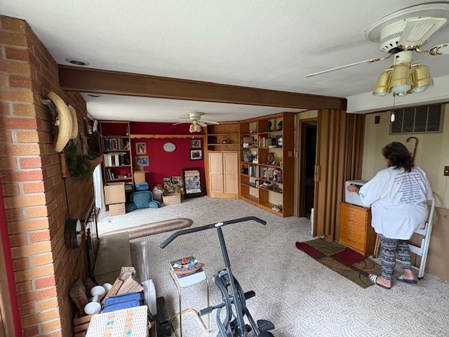 2119 Lakeview Ridge Dr NE, Solon, IA 52333 - carpeted living area featuring ceiling fan and beamed ceiling