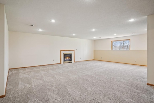 2135 Lake View Ridge Dr NE, Solon, IA 52333 - basement featuring carpet flooring, recessed lighting, and a fireplace with flush hearth