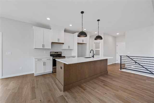 226 Mccarran Ave NE, Cedar Rapids, IA 52402 - kitchen with stainless steel range with electric stovetop, light wood-style flooring, white cabinetry, light countertops, and recessed lighting