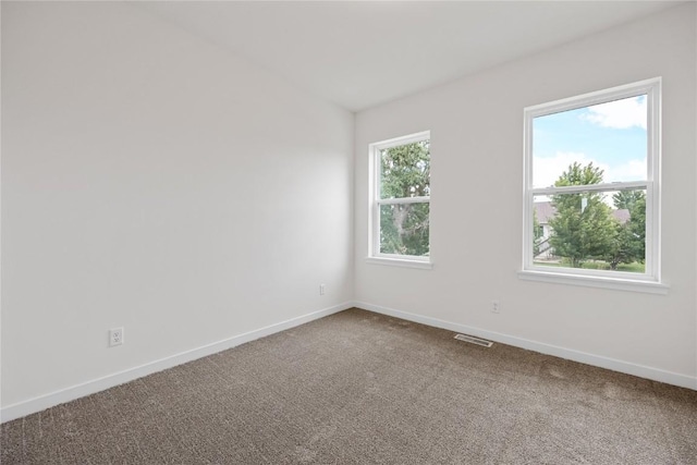 226 Mccarran Ave NE, Cedar Rapids, IA 52402 - empty room featuring dark carpet and baseboards