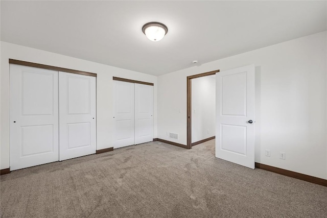 226 Mccarran Ave NE, Cedar Rapids, IA 52402 - unfurnished bedroom featuring two closets and carpet floors
