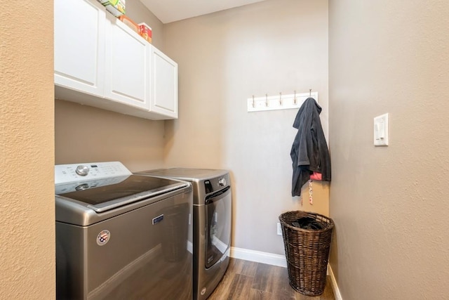 2654 Mulberry Ct, Marion, IA 52302 - washroom with cabinet space, washer and dryer, and dark wood-type flooring
