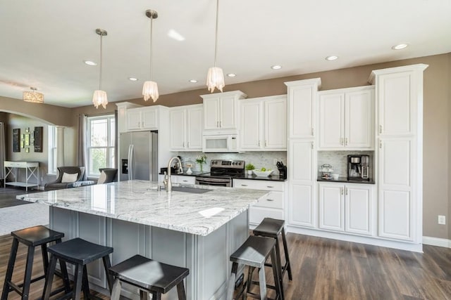 2654 Mulberry Ct, Marion, IA 52302 - kitchen featuring stainless steel appliances, dark wood finished floors, tasteful backsplash, white cabinetry, and recessed lighting