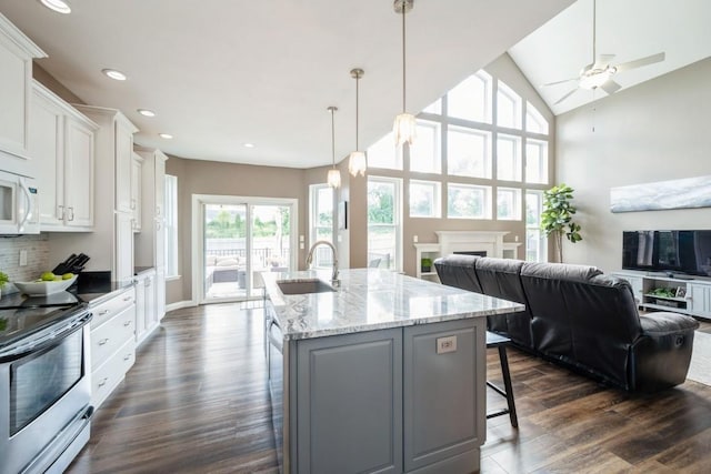 2654 Mulberry Ct, Marion, IA 52302 - kitchen featuring electric stove, open floor plan, recessed lighting, white cabinets, and dark wood-type flooring