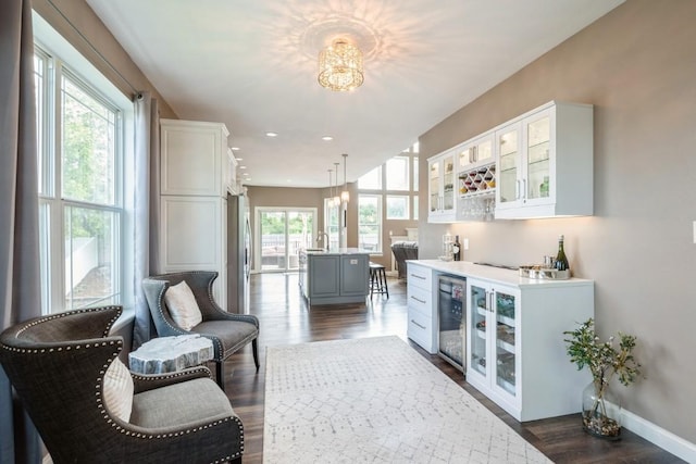 2654 Mulberry Ct, Marion, IA 52302 - indoor dry bar with wine cooler, dark wood-type flooring, decorative light fixtures, a chandelier, and recessed lighting