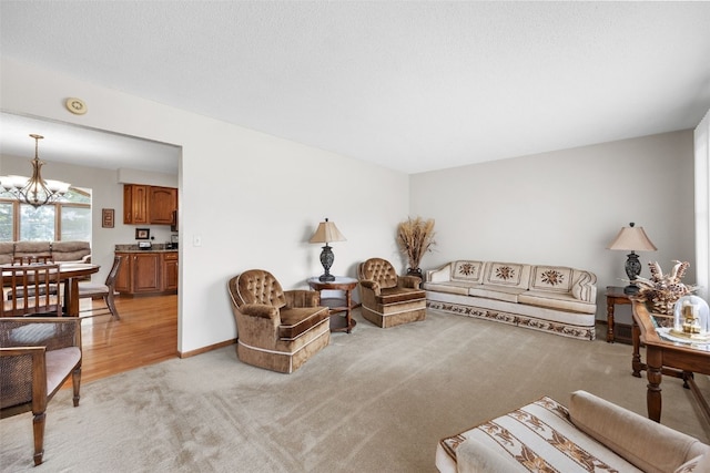 906 29th St NW, Cedar Rapids, IA 52405 - living room featuring light colored carpet and a chandelier