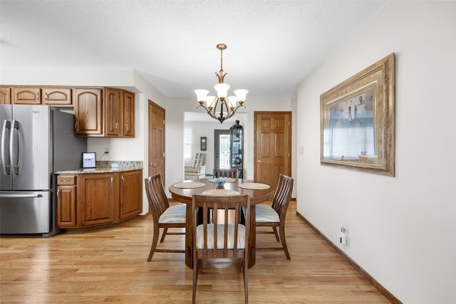 906 29th St NW, Cedar Rapids, IA 52405 - dining room featuring light wood-style flooring and a chandelier