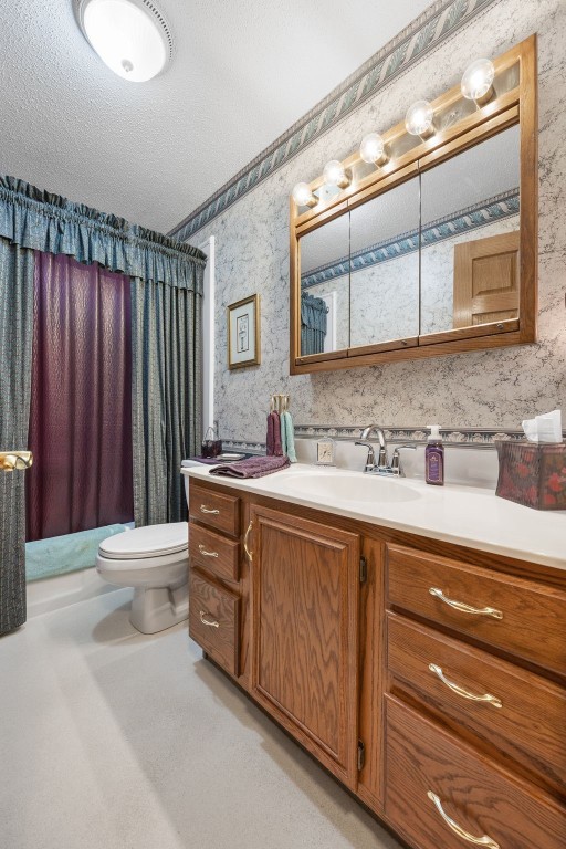 906 29th St NW, Cedar Rapids, IA 52405 - full bathroom featuring wallpapered walls, vanity, a shower with curtain, and a textured ceiling