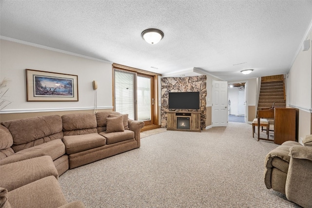 906 29th St NW, Cedar Rapids, IA 52405 - living room with stairway, a textured ceiling, ornamental molding, a stone fireplace, and light carpet