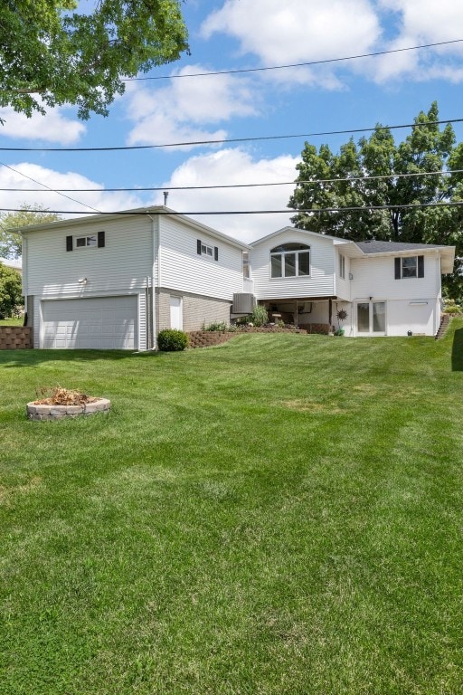 906 29th St NW, Cedar Rapids, IA 52405 - rear view of house with a garage and a yard