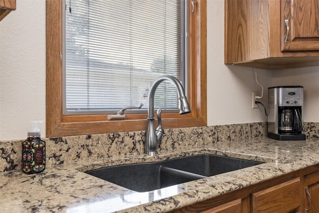 906 29th St NW, Cedar Rapids, IA 52405 - kitchen with brown cabinets, light stone counters, and tasteful backsplash