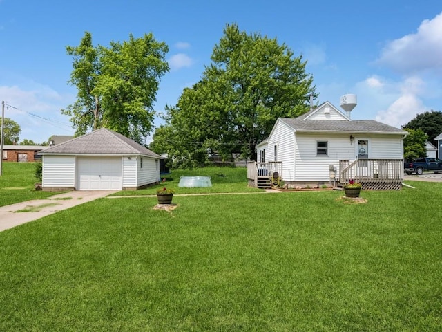 1 E Jefferson Ave S, Urbana, IA 52345 - view of green lawn featuring a detached garage, an outbuilding, driveway, and a deck