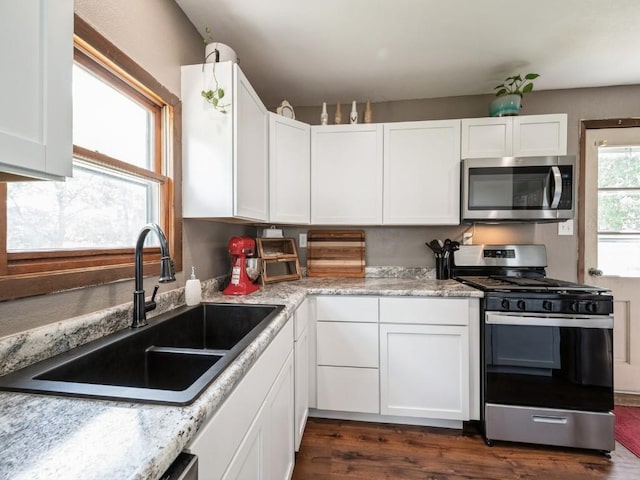 1 E Jefferson Ave S, Urbana, IA 52345 - kitchen featuring stainless steel appliances, dark wood-style floors, and white cabinets